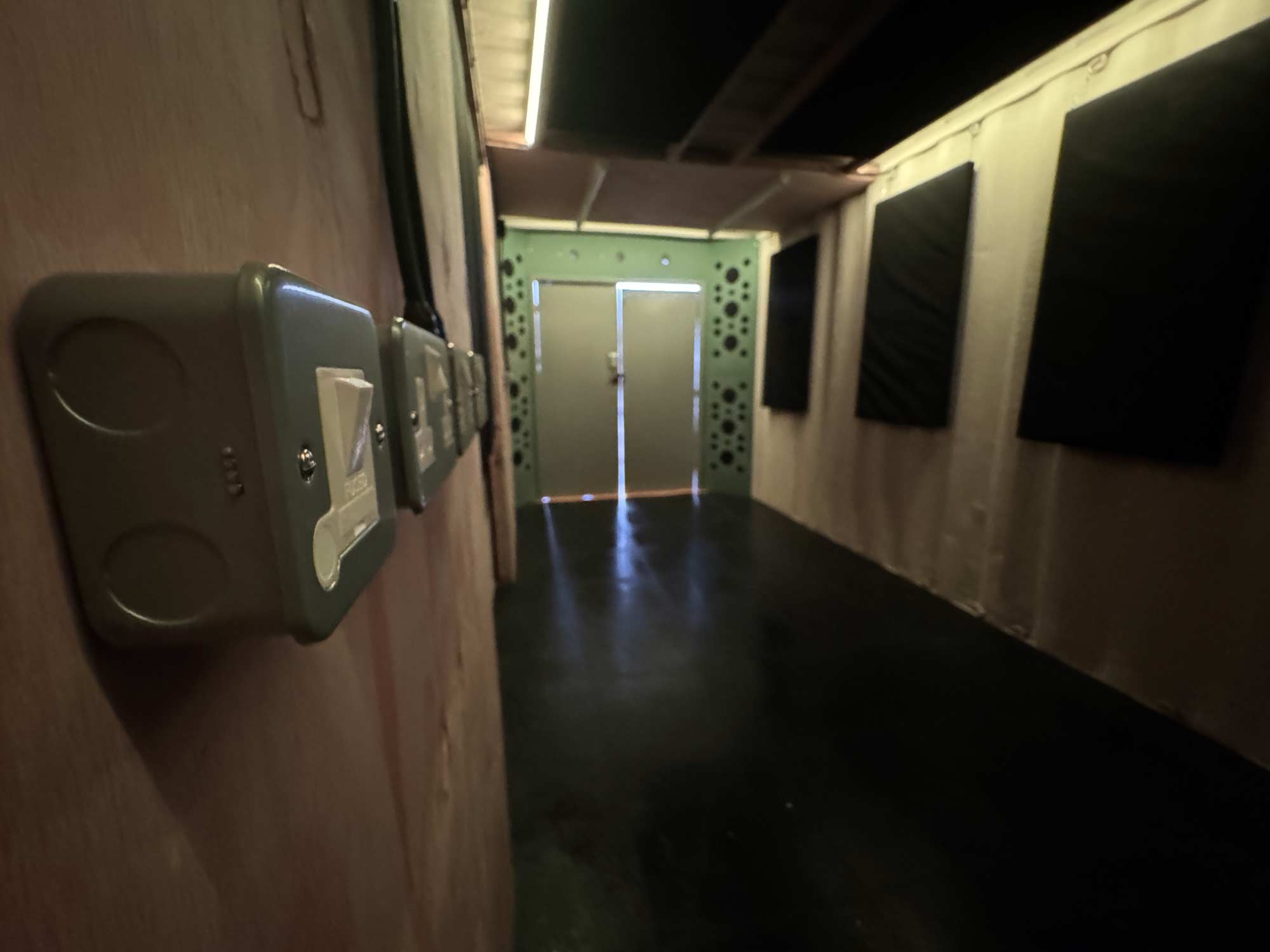 Music studio container interior with sculpted feature walls and mood lighting